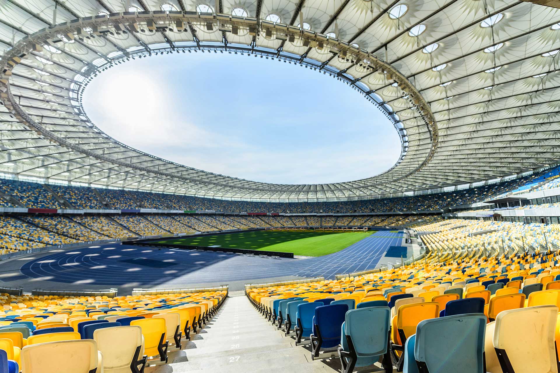 rows-of-yellow-and-blue-stadium-seats-on-soccer-fi-2022-12-16-18-38-59-utc-resize