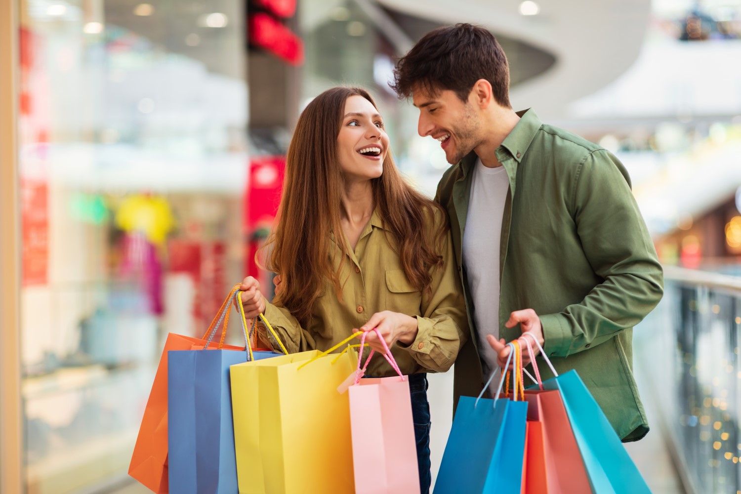 joyful-couple-on-shopping-laughing-holding-shopper-2022-12-16-07-50-18-utc